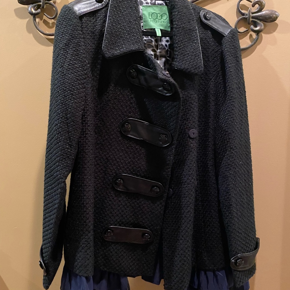 Brand new never been worn jacket. Black with black and navy removable ruffle